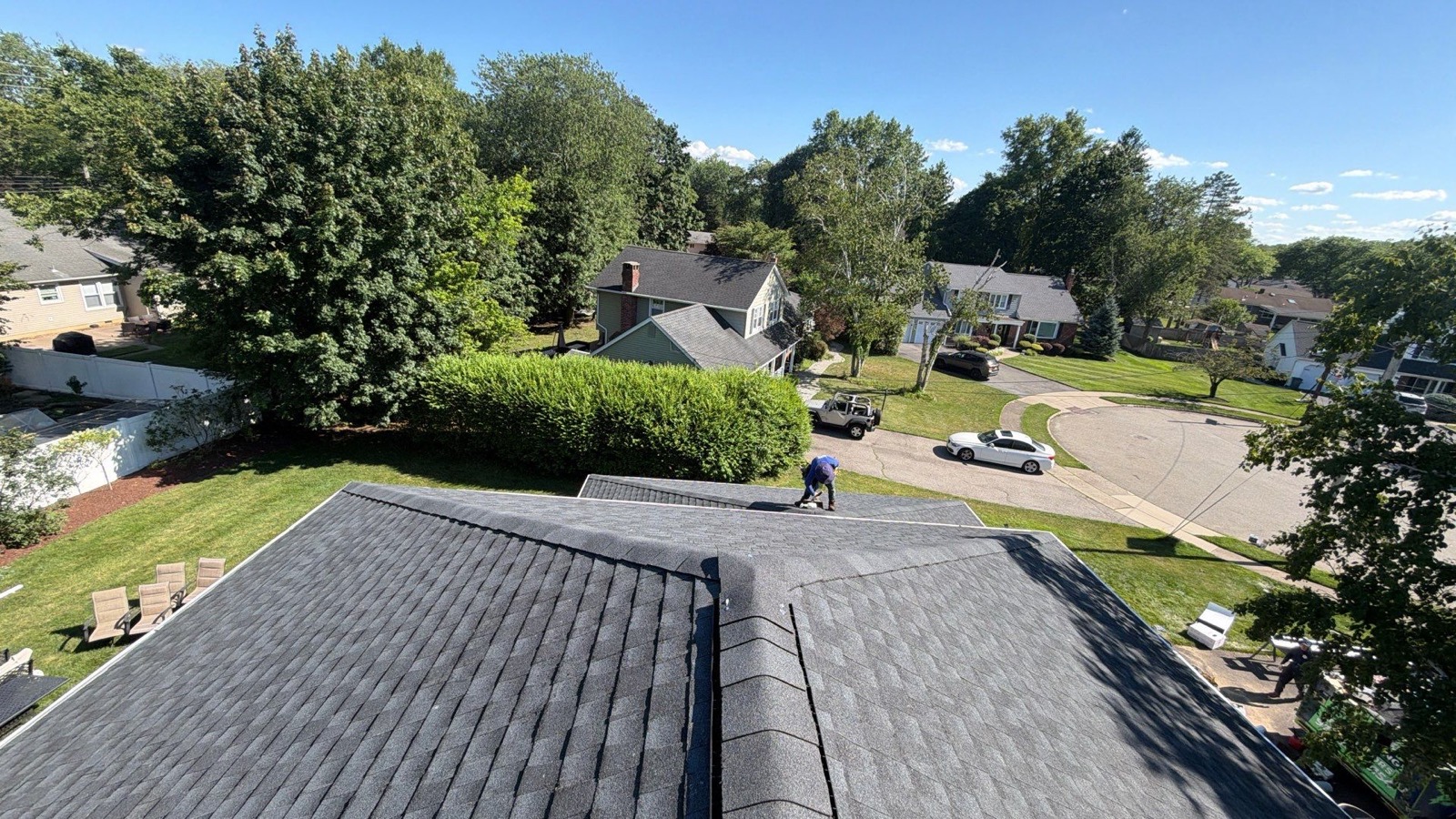 Drone angle of a completed colonial roof showing clean shingle lines and ridge vent installation