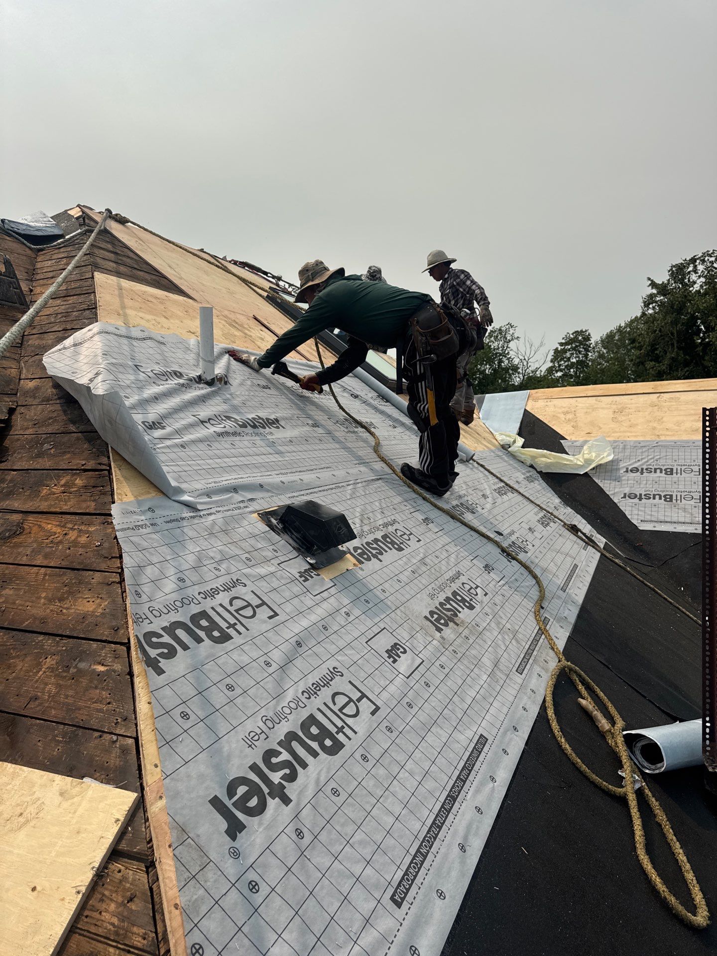 Ground-level view of a completed roof replacement on a white North Jersey colonial