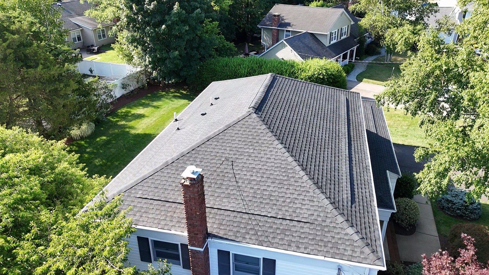LGM crew installing new GAF shingles over FeltBuster underlayment on a North Jersey home