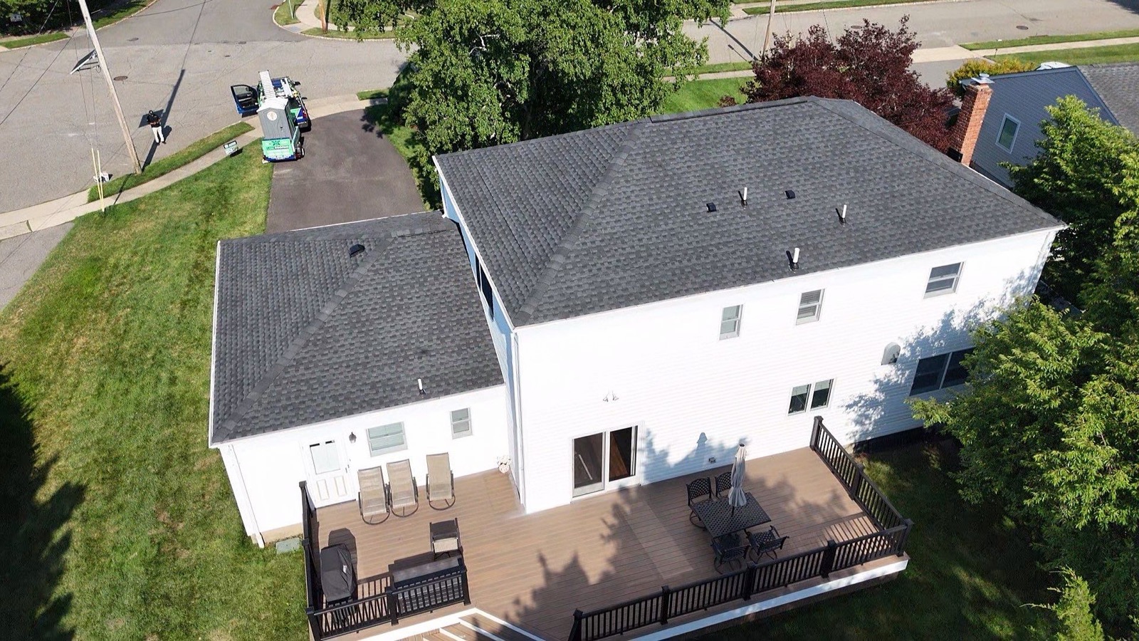 LGM crew on a roof with FeltBuster underlayment rolled out and GAF shingle bundles staged for install