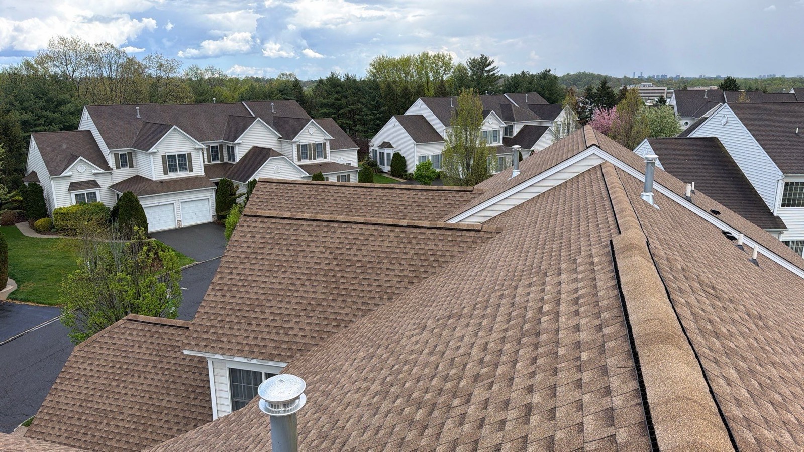 Completed suburban roof replacement shot from above — clean GAF Timberline HDZ shingles edge to edge