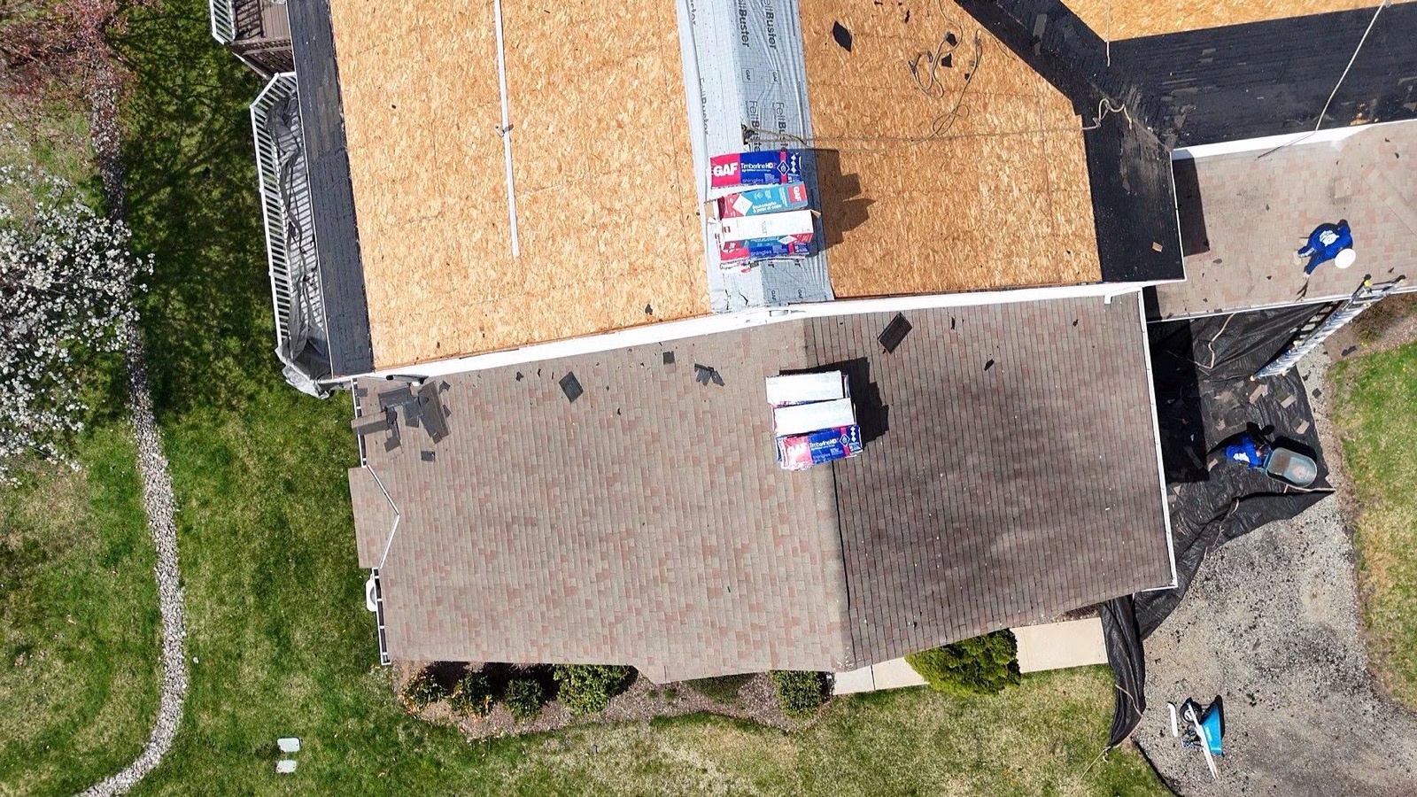 Drone view of FeltBuster synthetic underlayment rolled out across a resheathed suburban roof