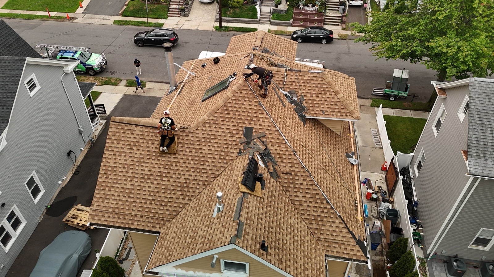 Completed tan Victorian roof from the backyard side showing clean valleys and ridge caps