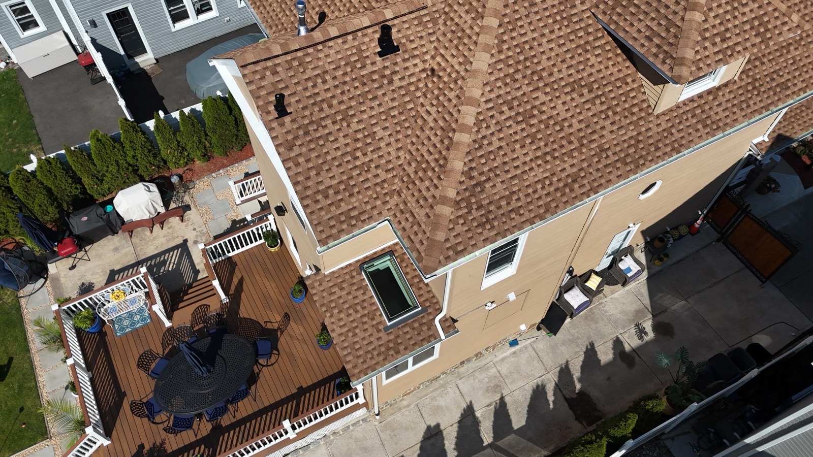 Final angle on a completed Victorian roof replacement showing clean ridge caps and chimney flashing