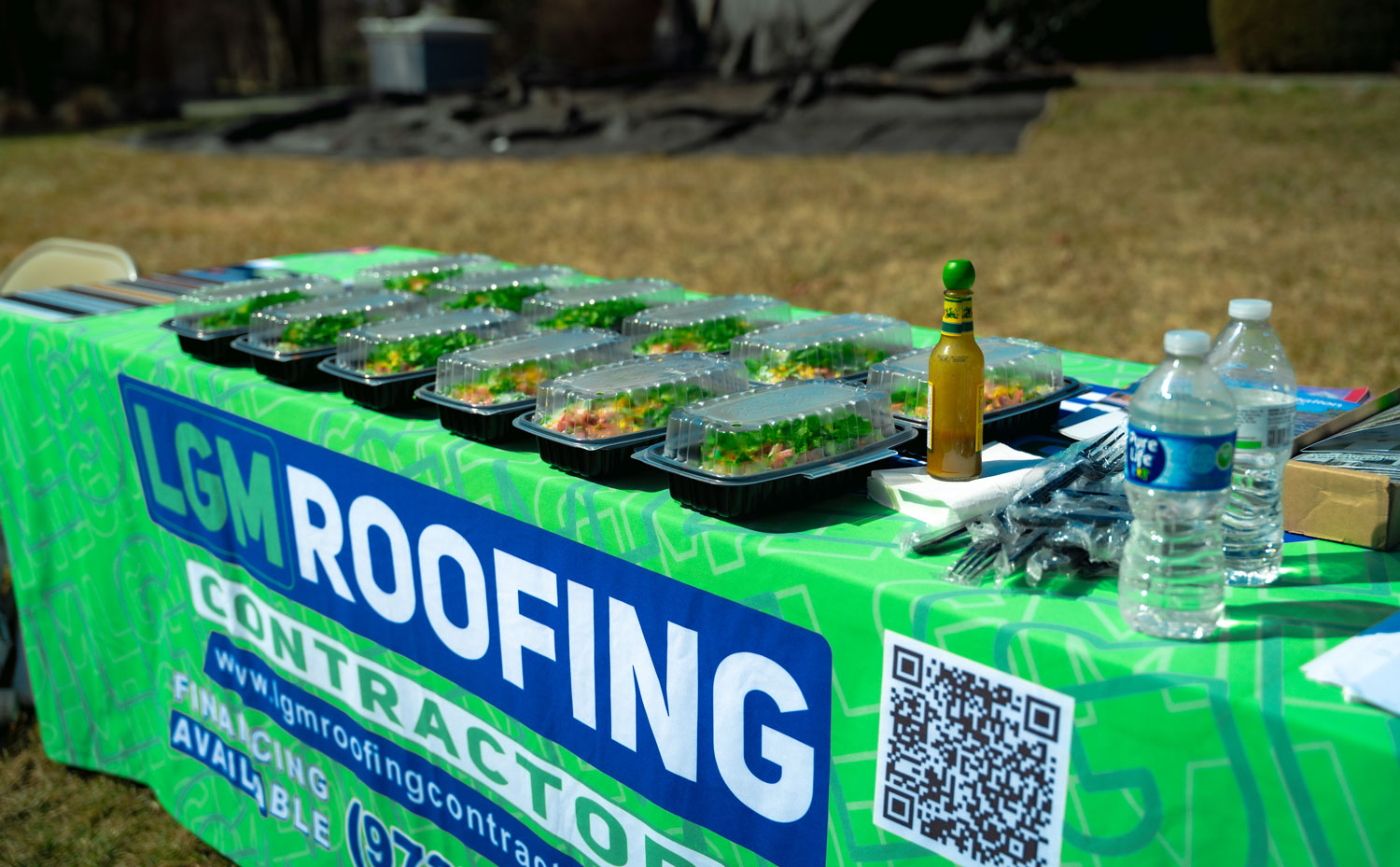 A branded LGM Roofing Contractors van at a job site