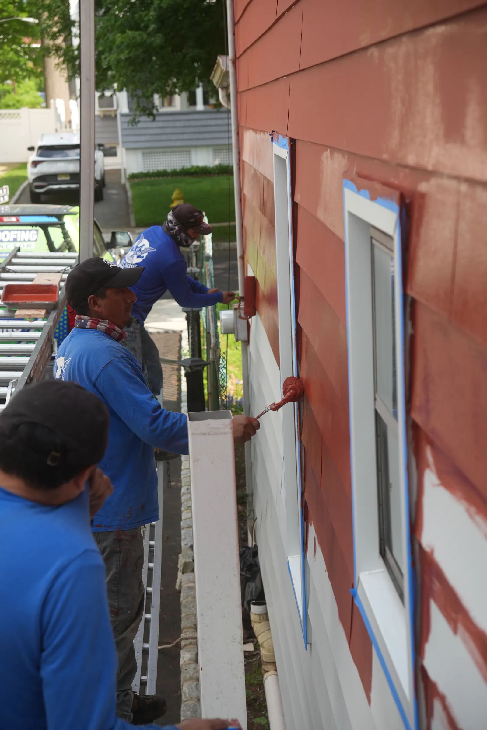 LGM crew installing new window trim during an exterior remodel