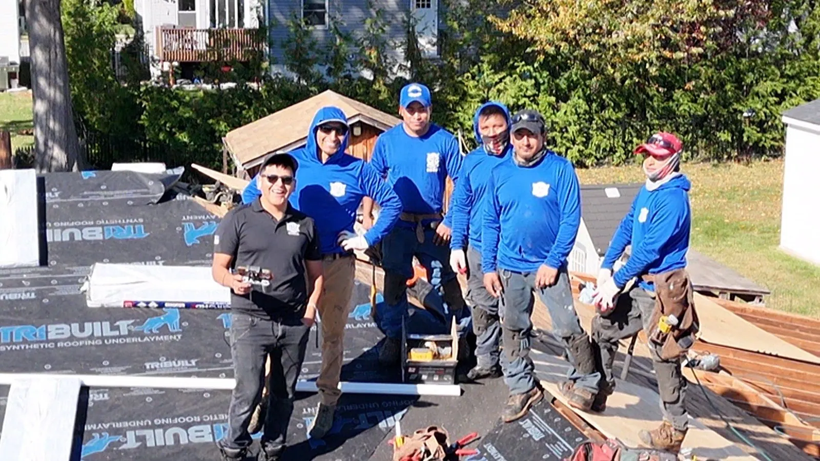 LGM Roofing crew standing together on a roof they replaced in North Jersey