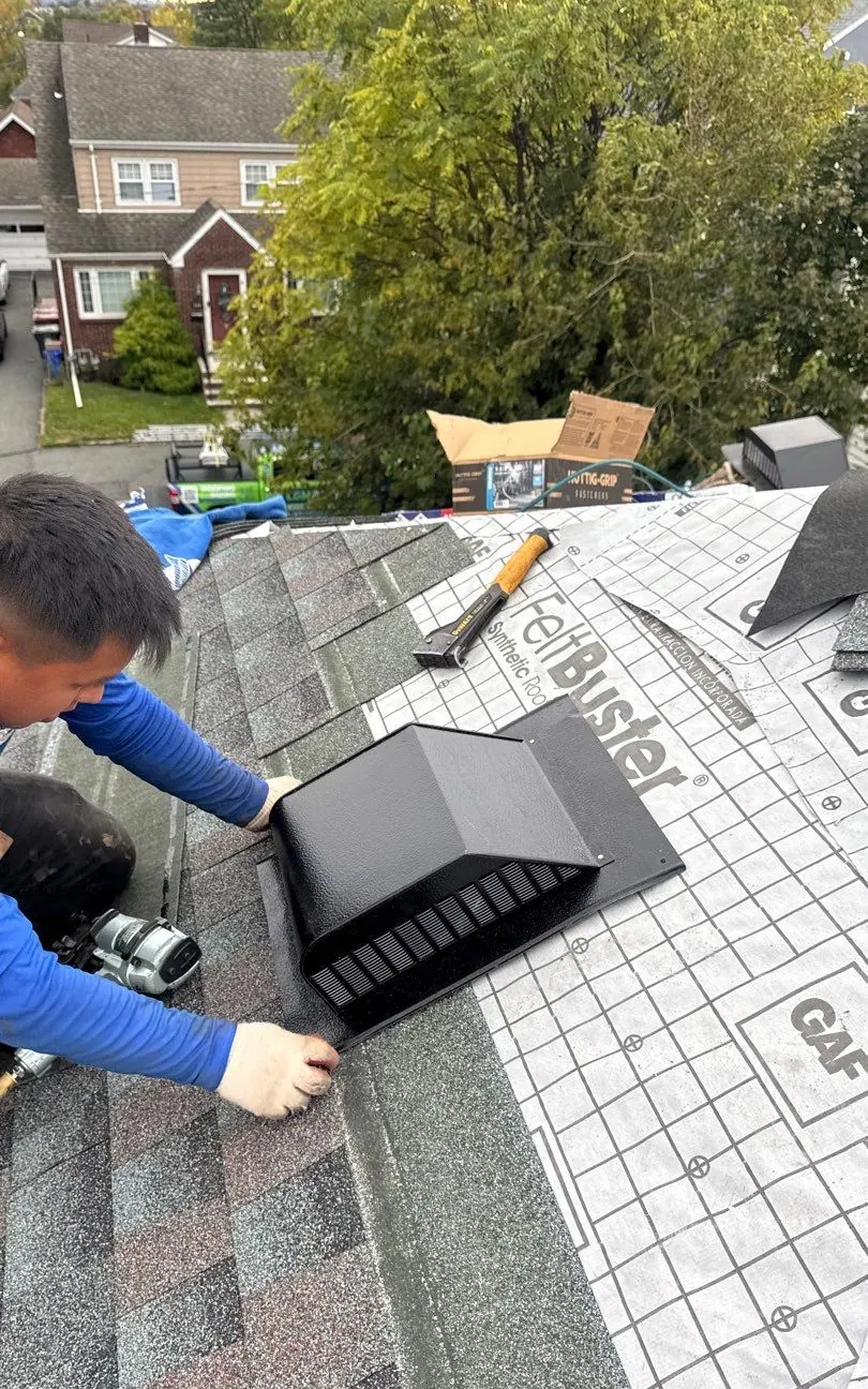LGM roofer fitting a ridge vent over new GAF shingles and FeltBuster underlayment