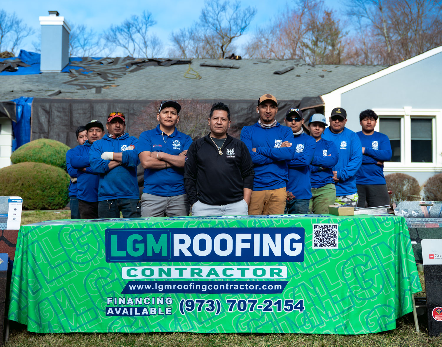 The LGM Roofing crew at a North Jersey job site with the LGM Roofing banner