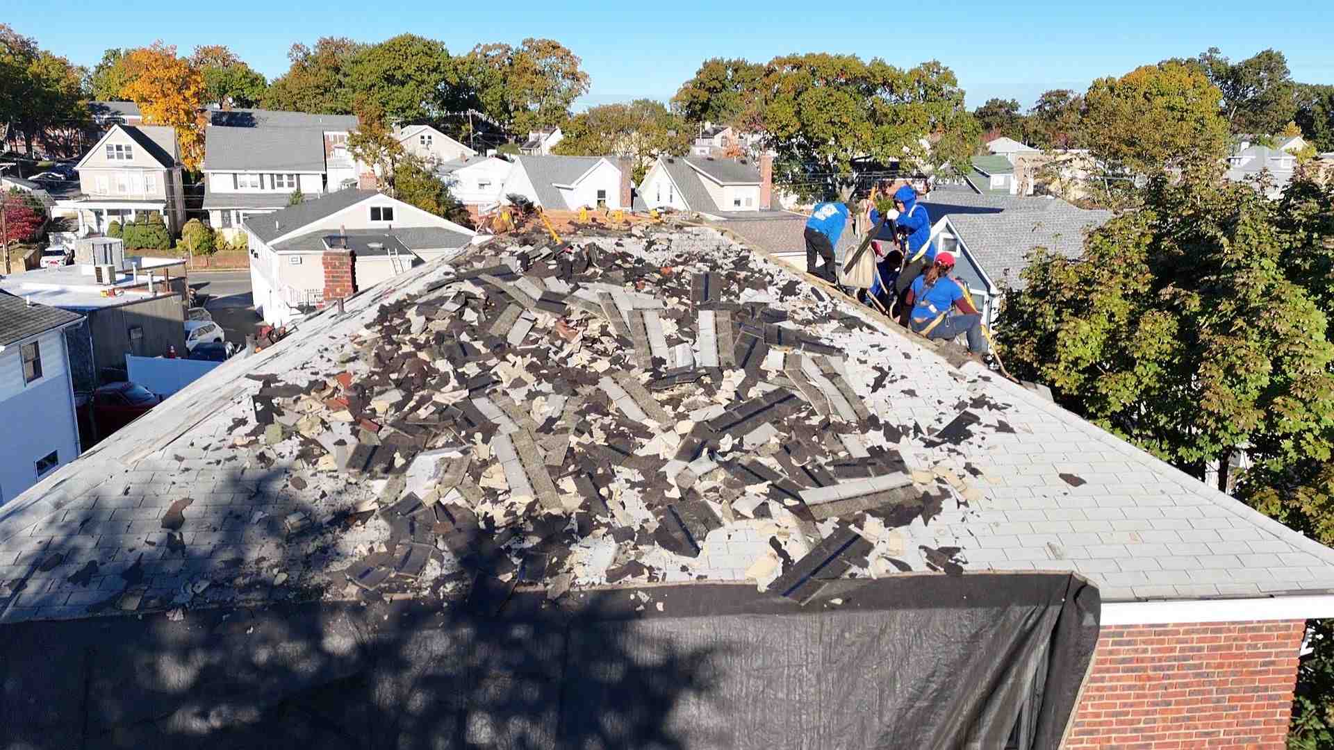 hail damaged asphalt shingles on residential roof after storm