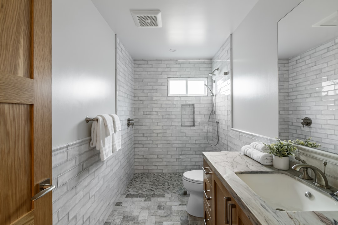 clean demolished bathroom space ready for rough-in plumbing and electrical showing exposed studs and subfloor - how long